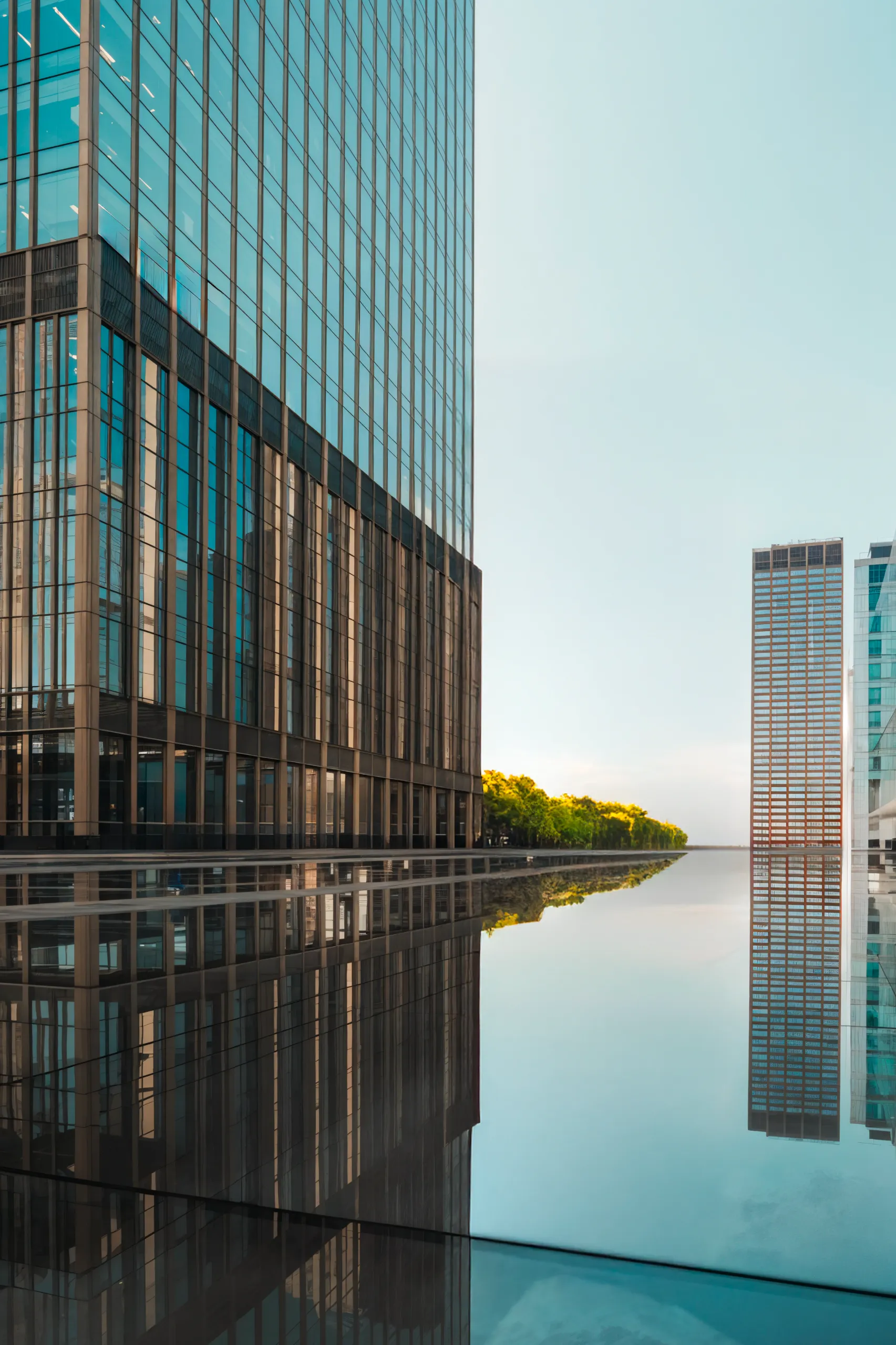 Futuristic skyscrapers in Vilnius with reflective geometric facades under a clear sky.